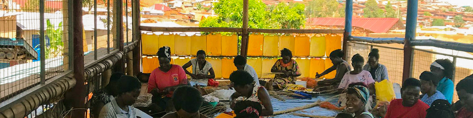 group of women artisans in kampala weaving baskets and home decor